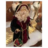 18 inch Santa in his black robe with shades of other colors and gold chains