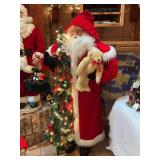 Life size Santa very pristine with lights, holly and garland and stuffed animals, this is rare and surely vintage.