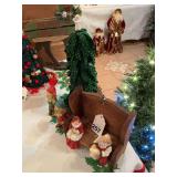 Santa and Mrs. Clause resting on a wooden bench with 2 dwarfs and miniature cloth Christmas tree