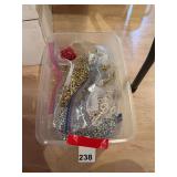 Plastic tub with about 12 bags of long Christmas beads, numerous colors, great when decorating a tree.