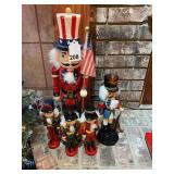 1 - 24 inch Nutcracker, 3 - 10 inch nutcrackers and 1 - 15 – inch, all wood and painted in Christmas colors.