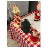 Lighted wooden light house, a glass lighted Church with a Steel Christmas Wizard