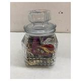 Glass jar full of vintage and costume jewelry