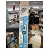 Black lamp post with outlet and cross arm.