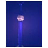 Smokers stand glows orange under Black light