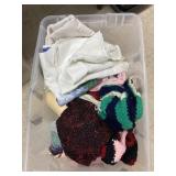 Tub of tablecloths, material, and crocheted vests