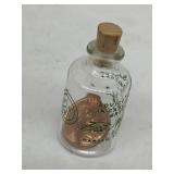 miniature glass bottle containing a penny