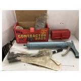 Box of post clips, caulk/grease gun, battery