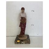 Figure with flowers on marble stand