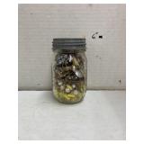 Ball jar filled with earrings and necklaces