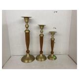 Trio of brass and wood candle holders