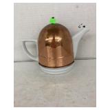 Ceramic tea pot with copper cozy