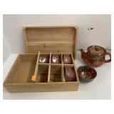 Teapot and cups in wooden box