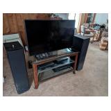 TV with entertainment center abd speakers