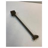 Brass barrel wrench.