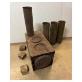 Wood stove. Metal. 24' x 12 x 12'. W chimney pipe