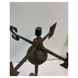 Cast iron weather vane on a stand.