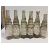 6 Nesbitt's pop bottles. 2 sizes. 3 types