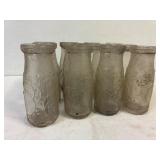 12 Half  pint embossed milk bottles.