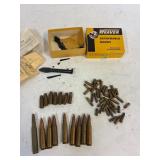 Assorted ammo and scope parts.