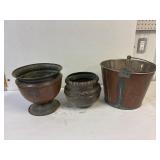 Copper pots and a pail.