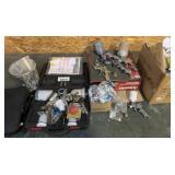lot of paint sprayers and parts