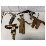 lot of cap gun belts and holsters, no cap guns