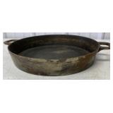 large unmarked cast iron frying pan