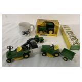 assorted John Deere toy tractors and mug