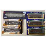 6 HO train cars in boxes