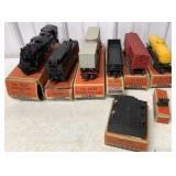 8 Lionel train cars and accessories in boxes
