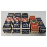 5 Champion spark plugs with boxes