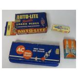assorted spark plugs in boxes