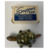 tin bobble turtle and Snapper Clip empty box