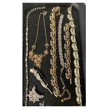 lot of necklaces, bracelets and pins