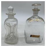 2 hand blown glass bottles with stoppers