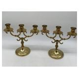 pair of brass candelabra marked EB on bottoms