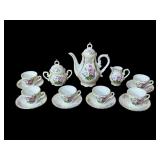 Porcelain tea set w/ teapot, creamer sugar etc