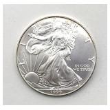 1999 Silver Eagle Dollar - includes plastic coin