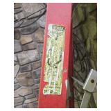 Red Fiberglass Ladder and Metal Sawhorse