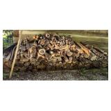 Stack of Firewood Against Wooden Wall