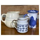 Three Ceramic Pitchers with Decorative Designs
