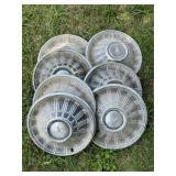 Seven Vintage Metal Hubcaps