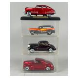 Four Die-Cast Model Cars with Display Case