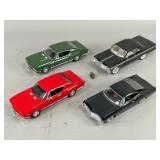 Four Diecast Model Cars in Assorted Colors