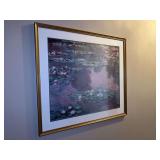 A framed print of Claude Monet