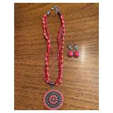 Great looking 4-strand coral colored beaded necklace with medallion pendant and matching teardrop earrings