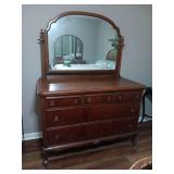 Antique 5 drawer dresser with tilt mirror. Open and closes well..52x24x72