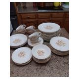 12 plates, 8 salad plates, 4 dessert (1 has crazing), 7 cups, 4 saucers, 7 fruit/dessert bowls..a couple pieces with discoloration. 45 pieces total. Vintage Wheat Pattern gold rubbing off some of the 