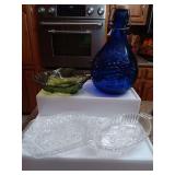 Group of glass pieces, Milano blue jug, vintage avocado strawberry bowl, and a couple of relish trays.
